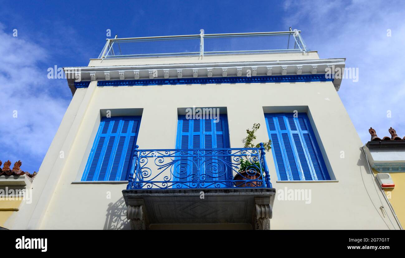 A beautiful Greek house with white walls and blue windows. Athens ...