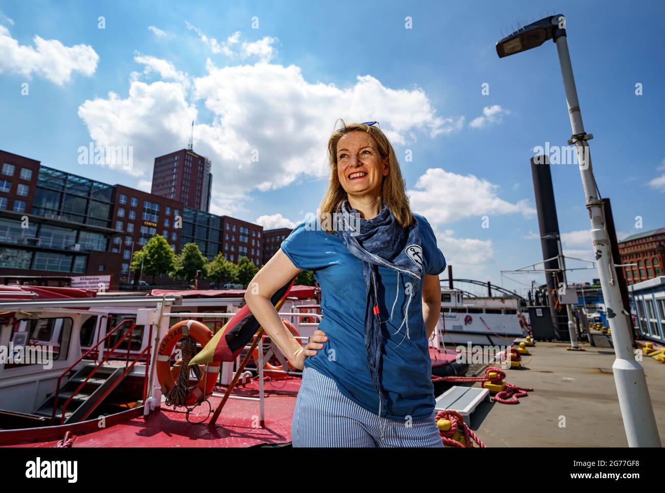 Hamburg, Germany. 25th June, 2021. Tour guide Maike Brunk stands in front of a launch before a tour of the Port of Hamburg. Brunk shows passengers hidden corners of the city on her tours. (to dpa KORR.: 'Sehnsuchtsort Hafen: Tour guide Maike Brunk shows hidden corners') Credit: Axel Heimken/dpa/Alamy Live News Stock Photo