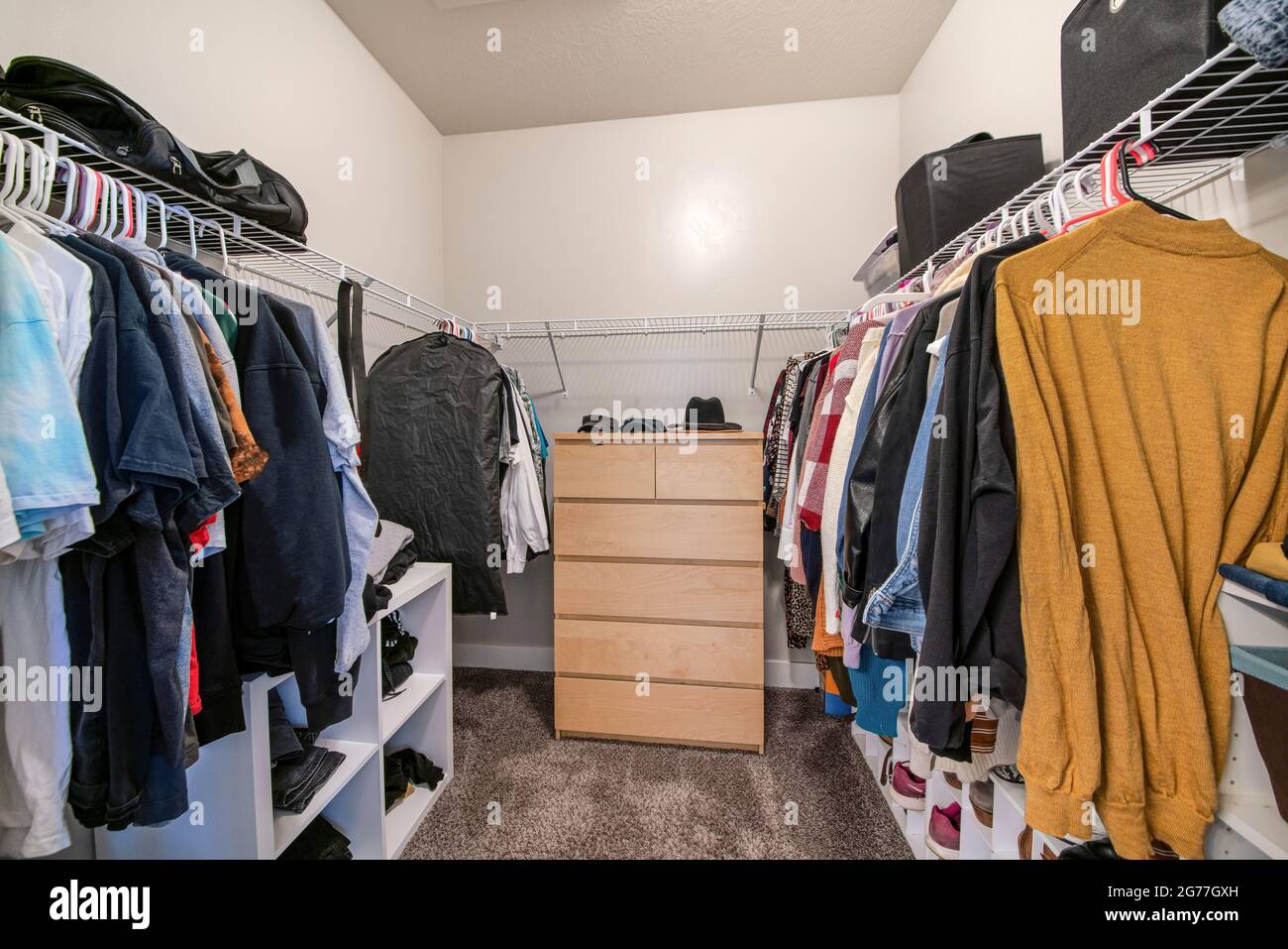 Full walk in closet with metal shelves and shoe organizer Stock Photo