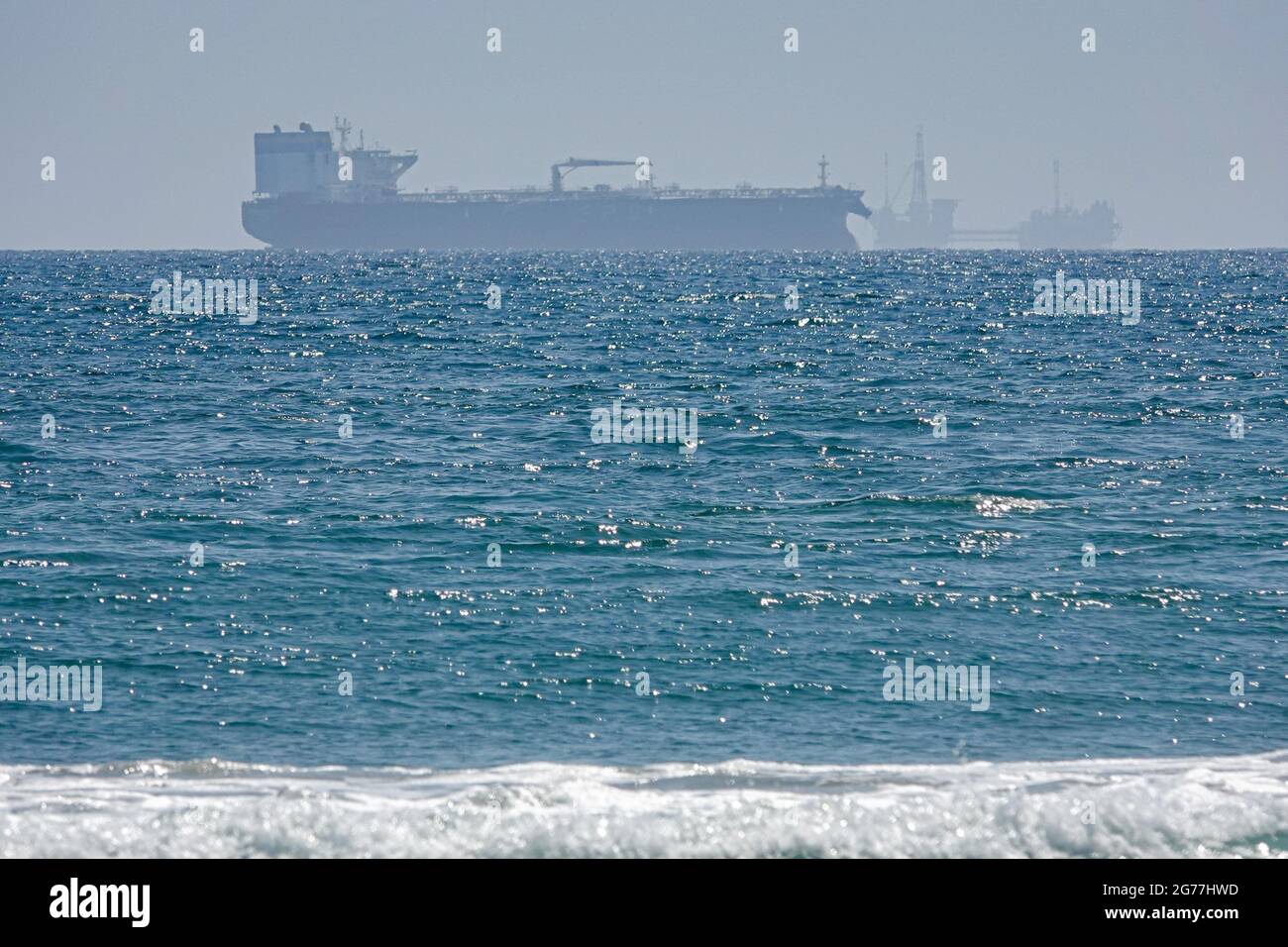 Oil rigs, freighters as well as sailboats and fishing boats all share the coastal waters off southern California. Stock Photo