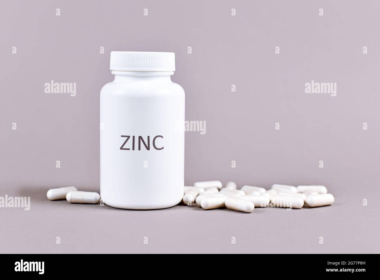 Bottle with Zinc mineral supplement inscription with capsules Stock Photo