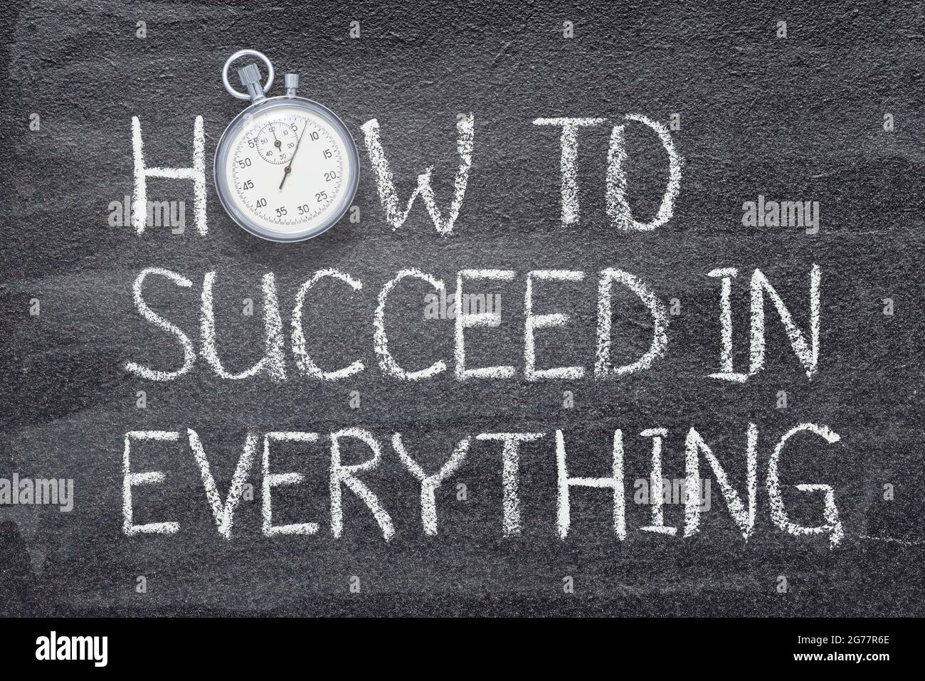 how to succeed in everything phrase written on chalkboard with vintage precise stopwatch Stock Photo
