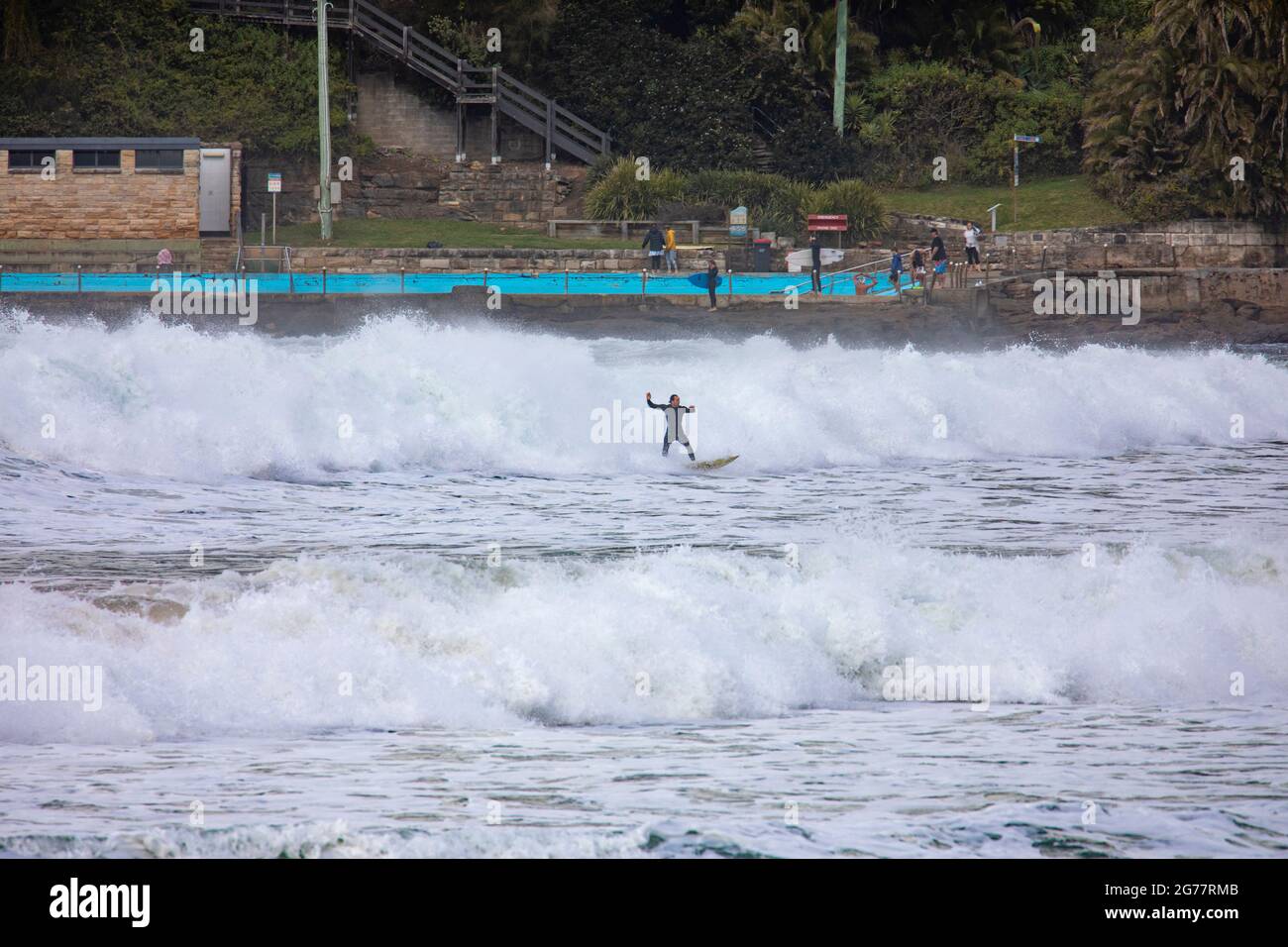 Palm Beach Sydney, australian surfer riding large ocean waves on a winters ay,Australia Stock Photo