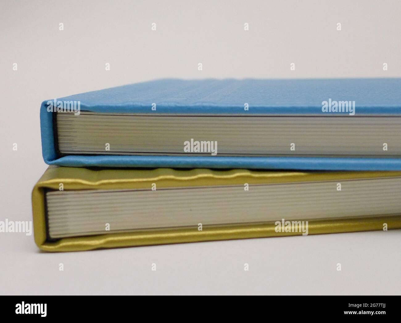 Stack of leather bound blue and gold books Stock Photo