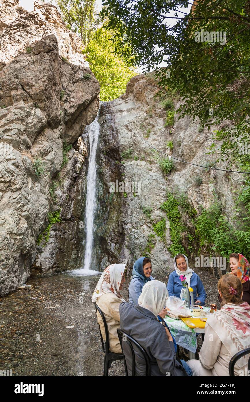 People resting at small waterfall, near Tochal Telecabin, Tochal mountain, Tehran, Iran, Persia, Western Asia, Asia Stock Photo