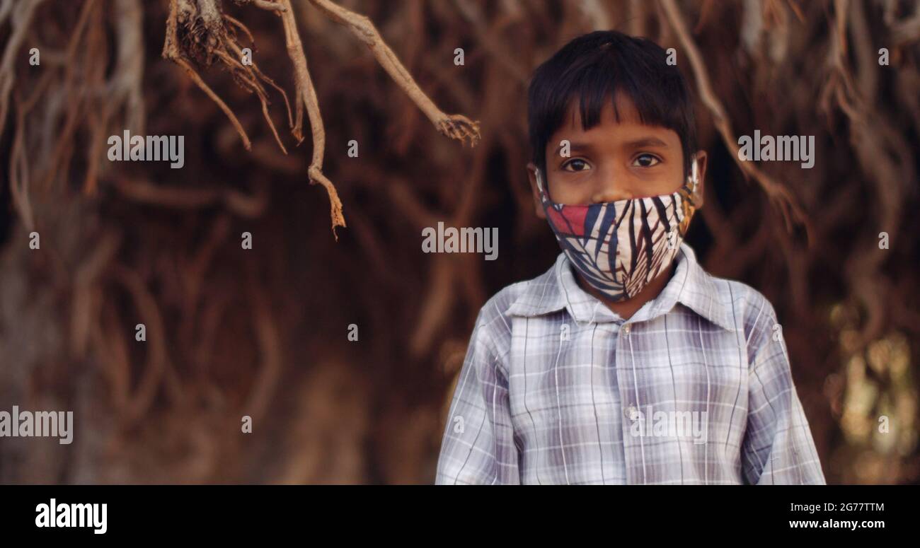 Closeup shot of an Indian boy wearing a mask new normal concept Stock