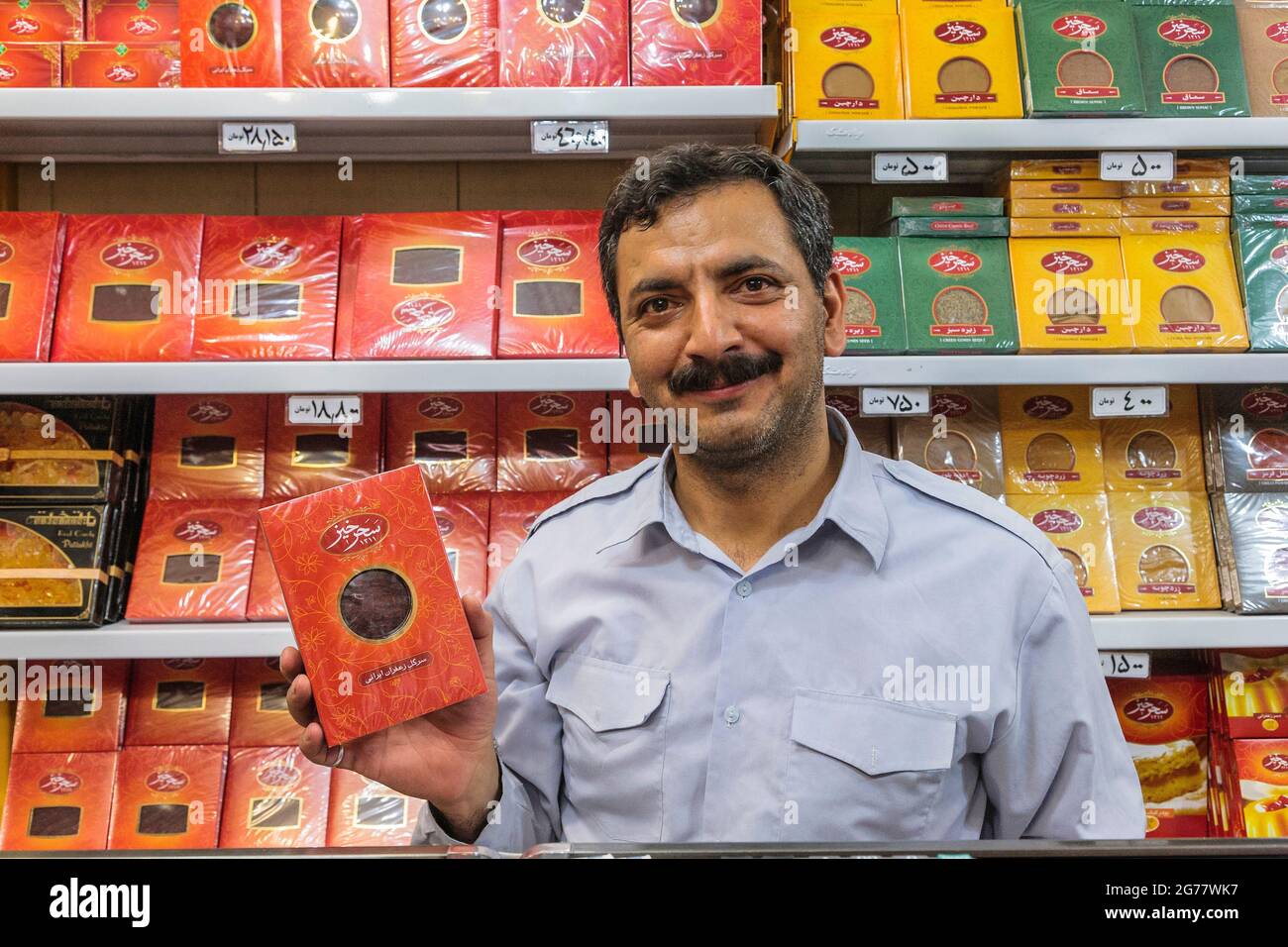 Shopkeeper shows iranian saffron, spice shop, Mashhad, Razavi Khorasan