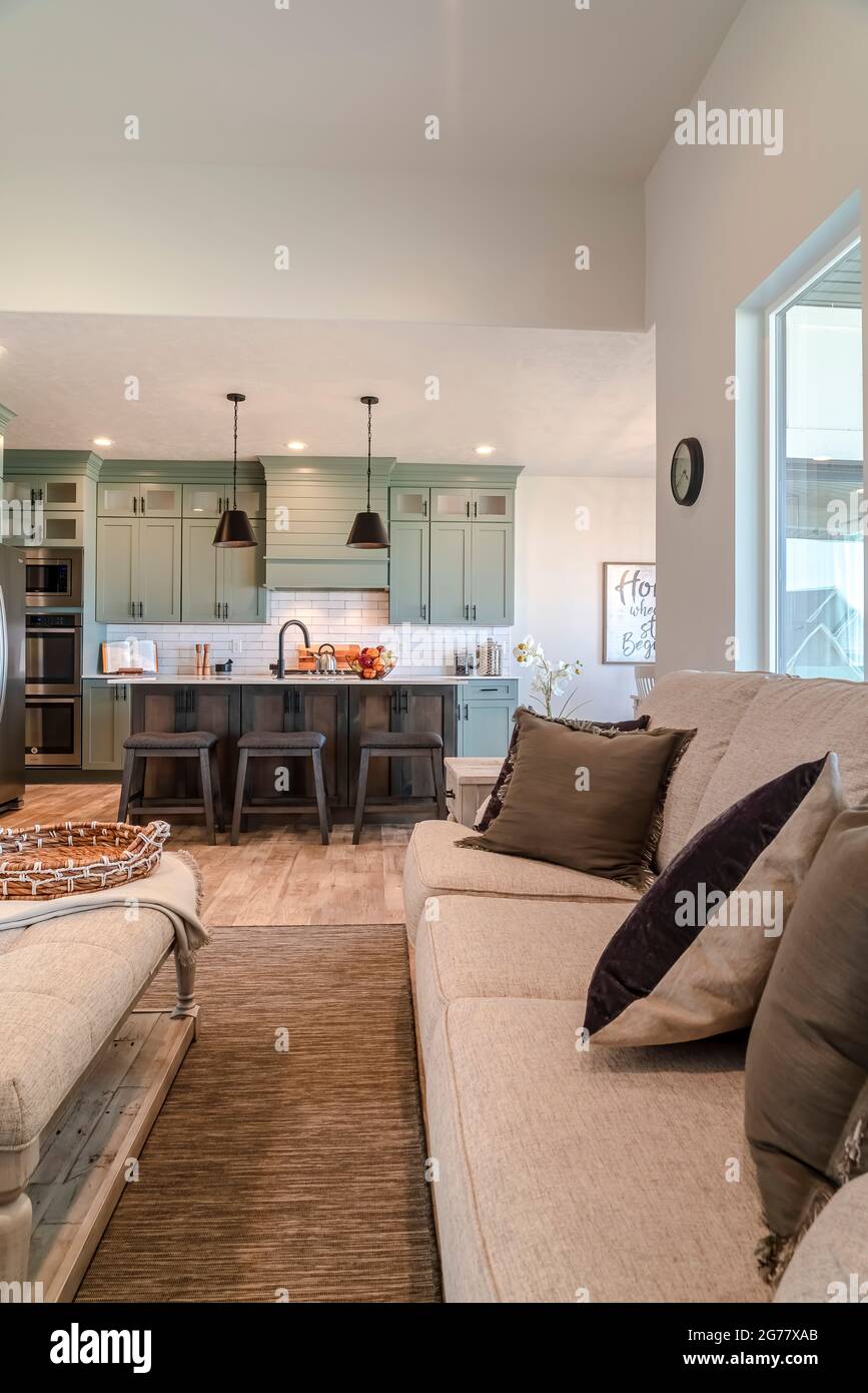 Couch and table at the living room with view of the kitchen island and
