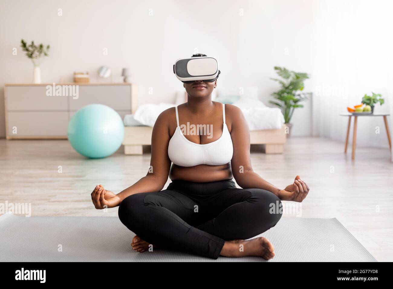 Plus Size Black Woman Sitting In Lotus Pose Meditating With Closed