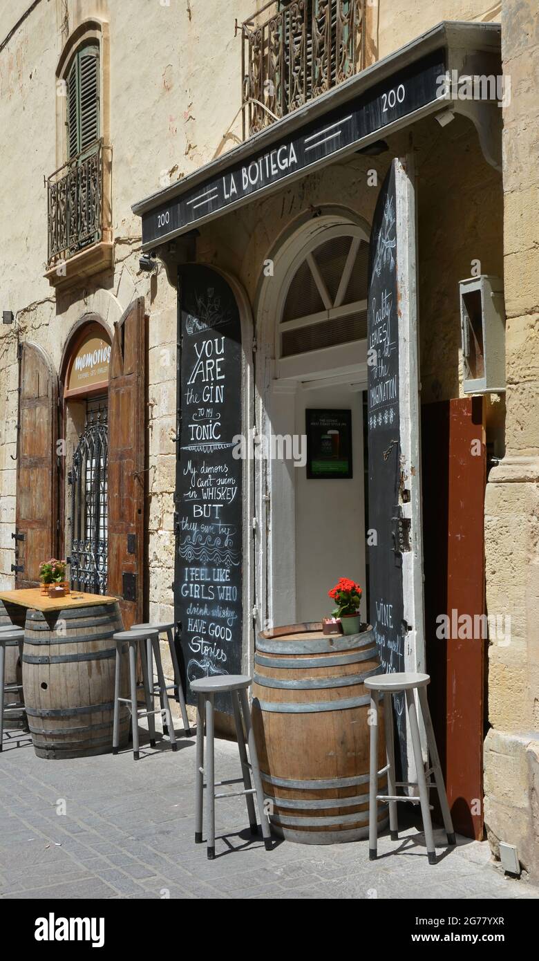 VALLETTA, MALTA - May 23, 2018: Empty seats outside the entrance to La Bottega bar and restaurant in Merchants Street, Valletta, Malta Stock Photo