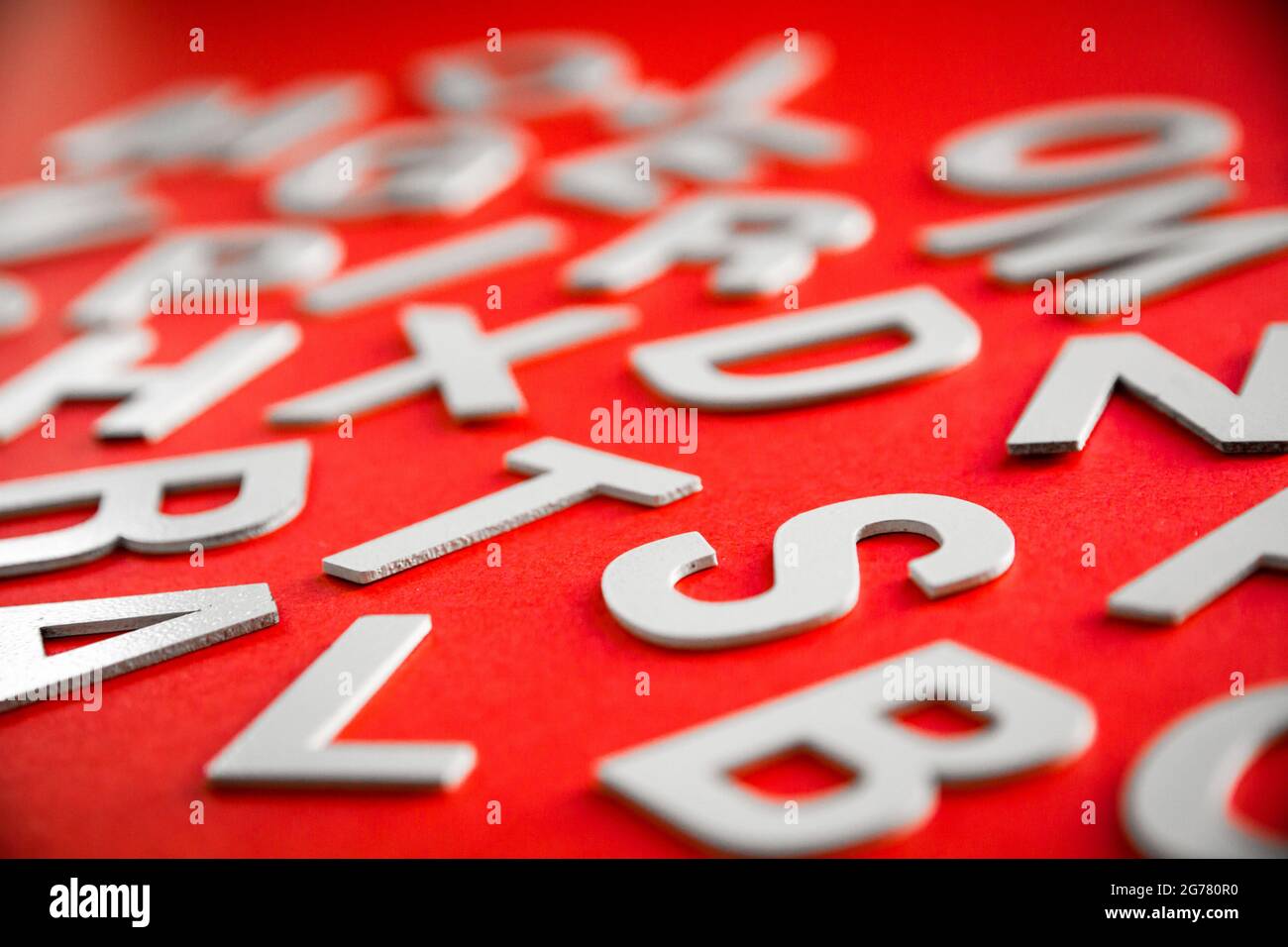 Mixed solid letters pile close up view photo. Education concept on red ...