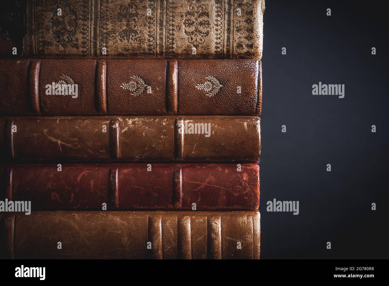 Stack of old books isolated on black background Stock Photo - Alamy