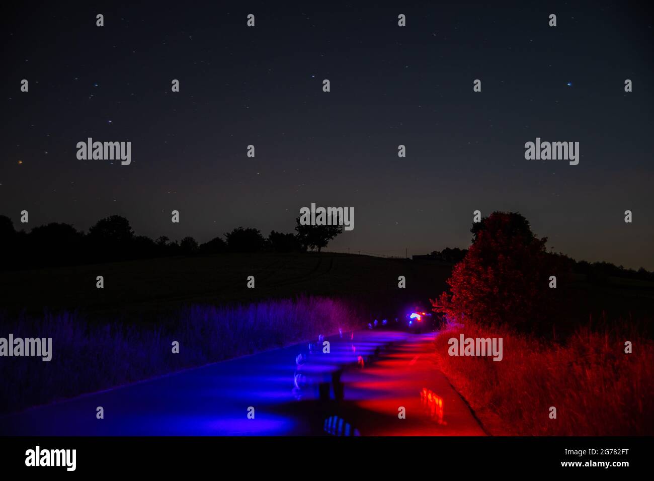 Countryroads illuminated colorfully past midnight Stock Photo