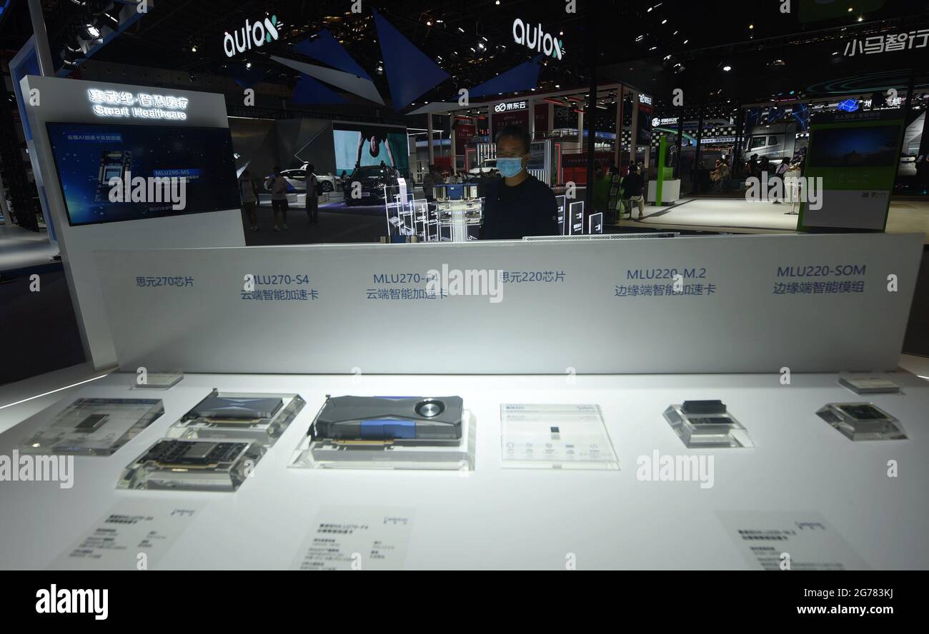 SHANGHAI, CHINA JULY 7, 2021 Visitors look at a series of AI chips developed by Cambrian at