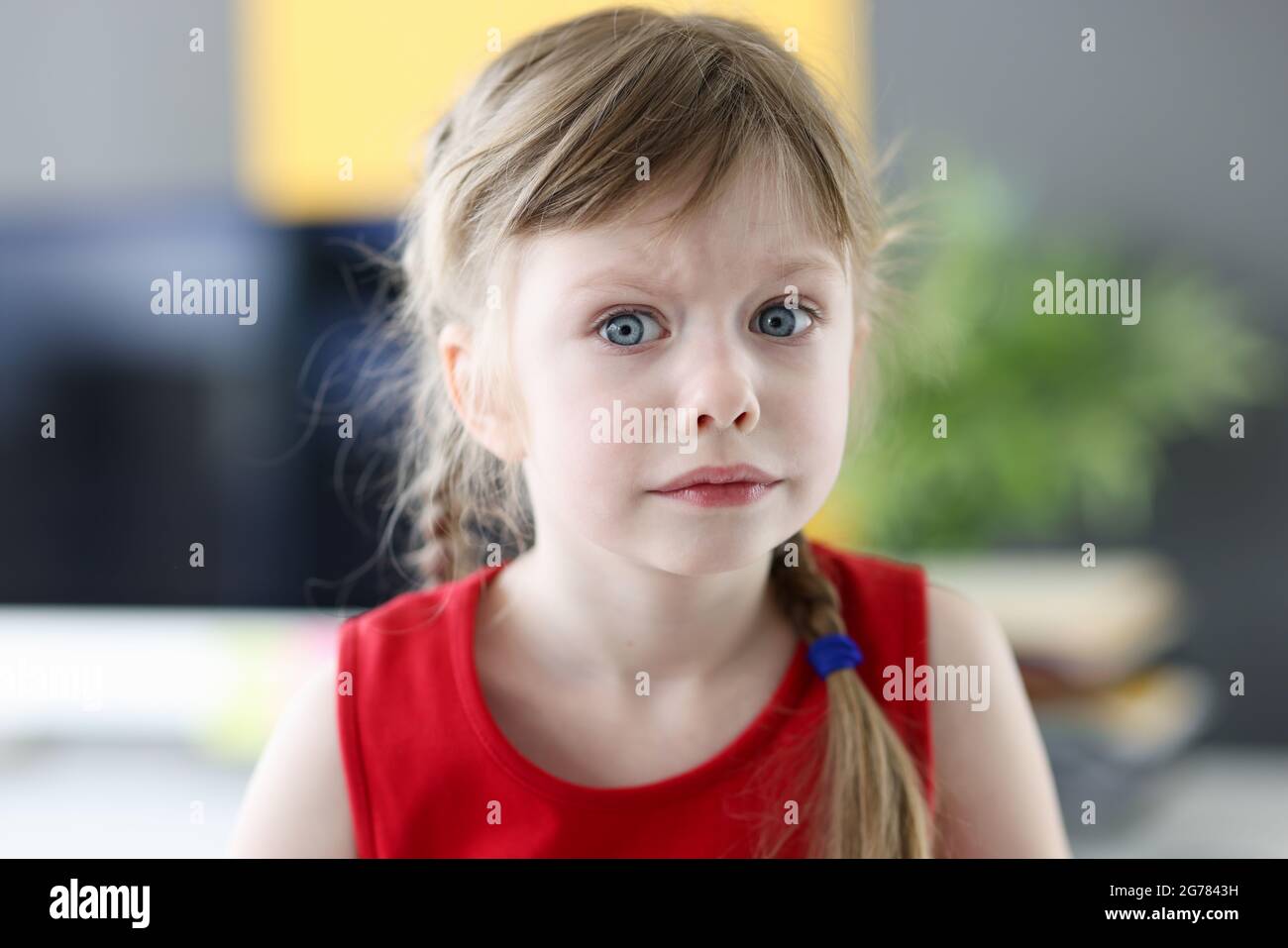 Portrait of little emotional girl with pensively frightened look closeup Stock Photo