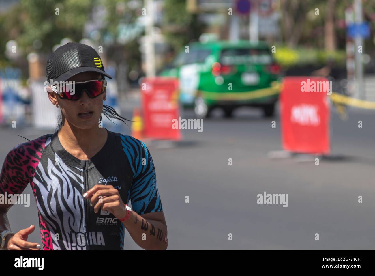 Johanna Solano is a triathlon participant in the Challenge Vietnam event,  she runs a 21 kilometer stretch along Tran phu Street near the South China  S Stock Photo - Alamy