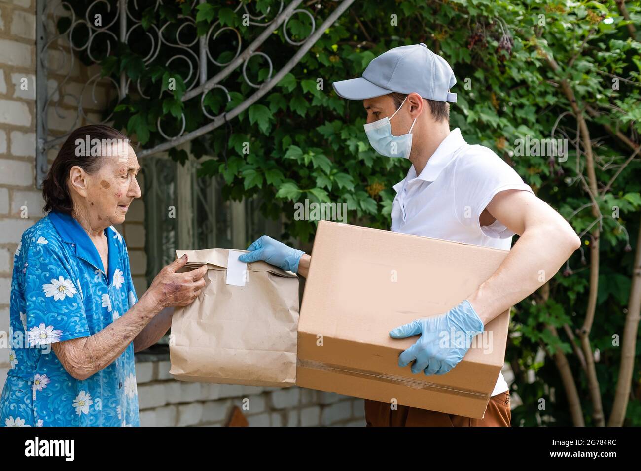 food delivery man for an elderly woman Stock Photo Alamy