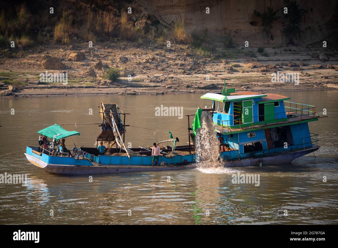 Dredging for gold on the Irrawaddy River, Bagan, Myanmar. Gold is extracted from silt on the river bed, processed and pressed into gold leaf Stock Photo