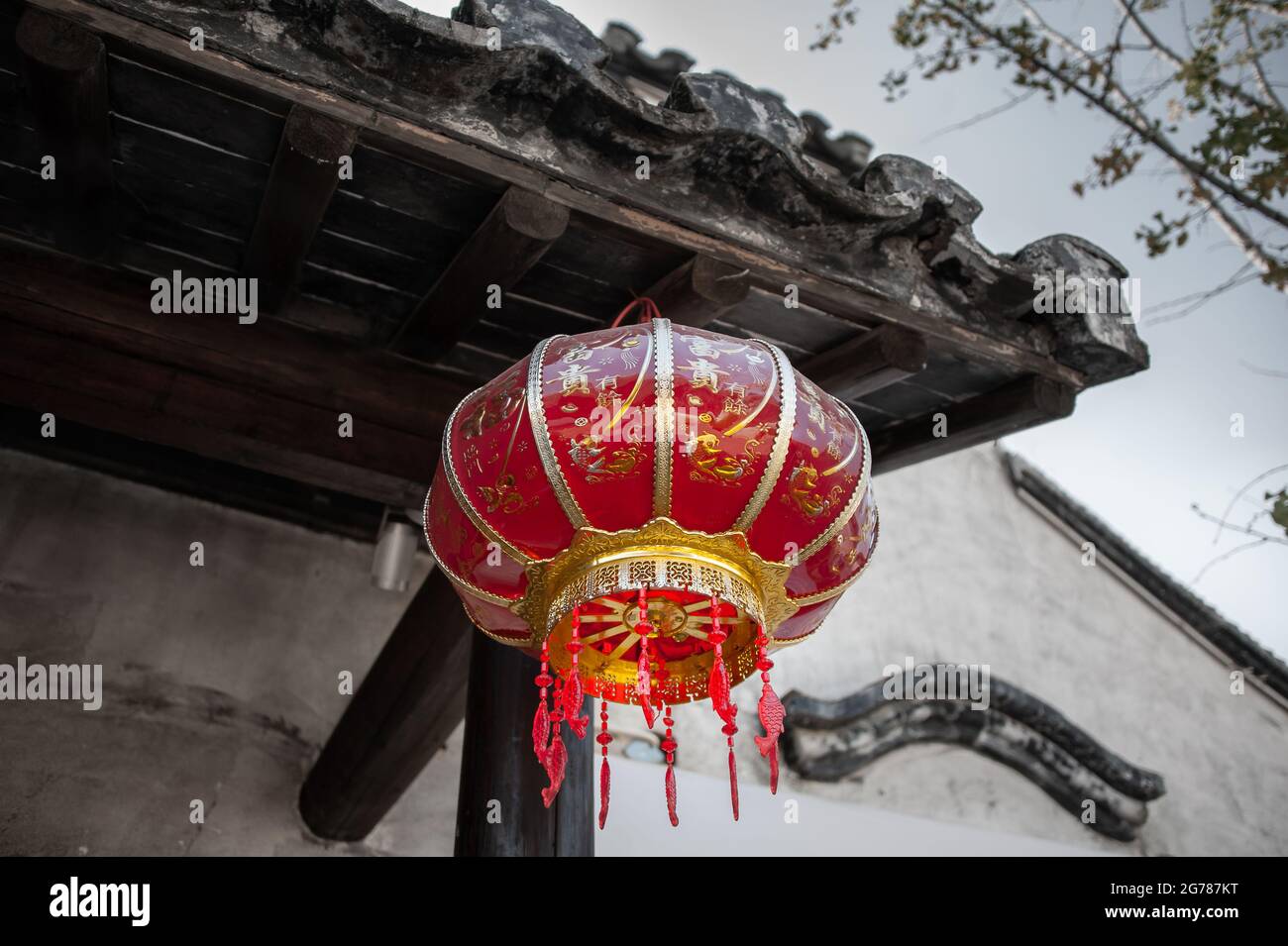 Jiangsu: Decorative chinese lantern hanging from an old building. These red lanterns are widely seen throughout China, often celebrating festivals Stock Photo