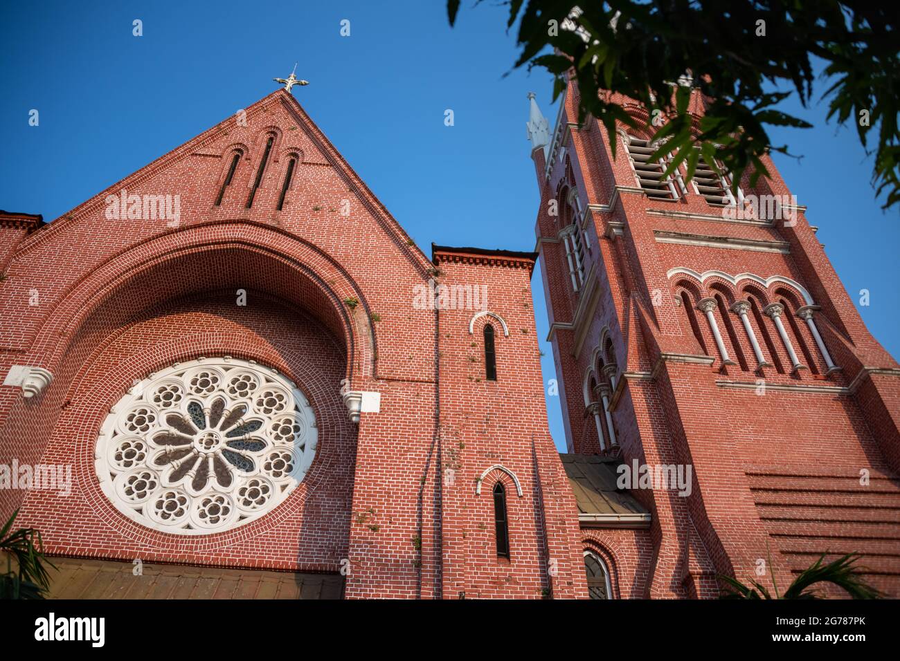 St. Mary's Cathedral or Immaculate Conception Cathedral, Yangon, Myanmar. Exterior view, red brick building with blue sky background Stock Photo
