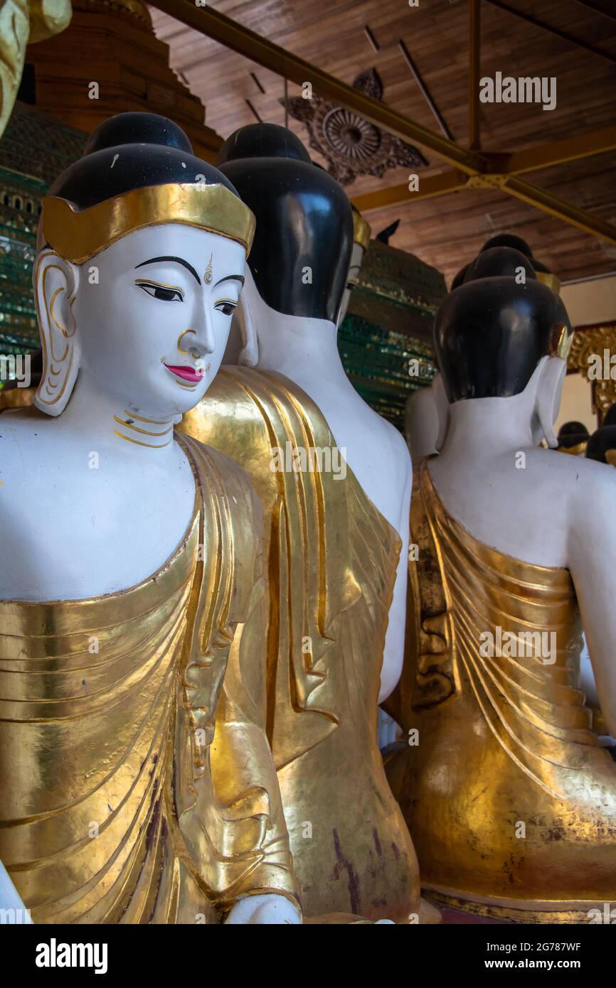 Yangon, Myanmar - January 2020: Golden Buddha statues, Shwedagon Pagoda Stock Photo