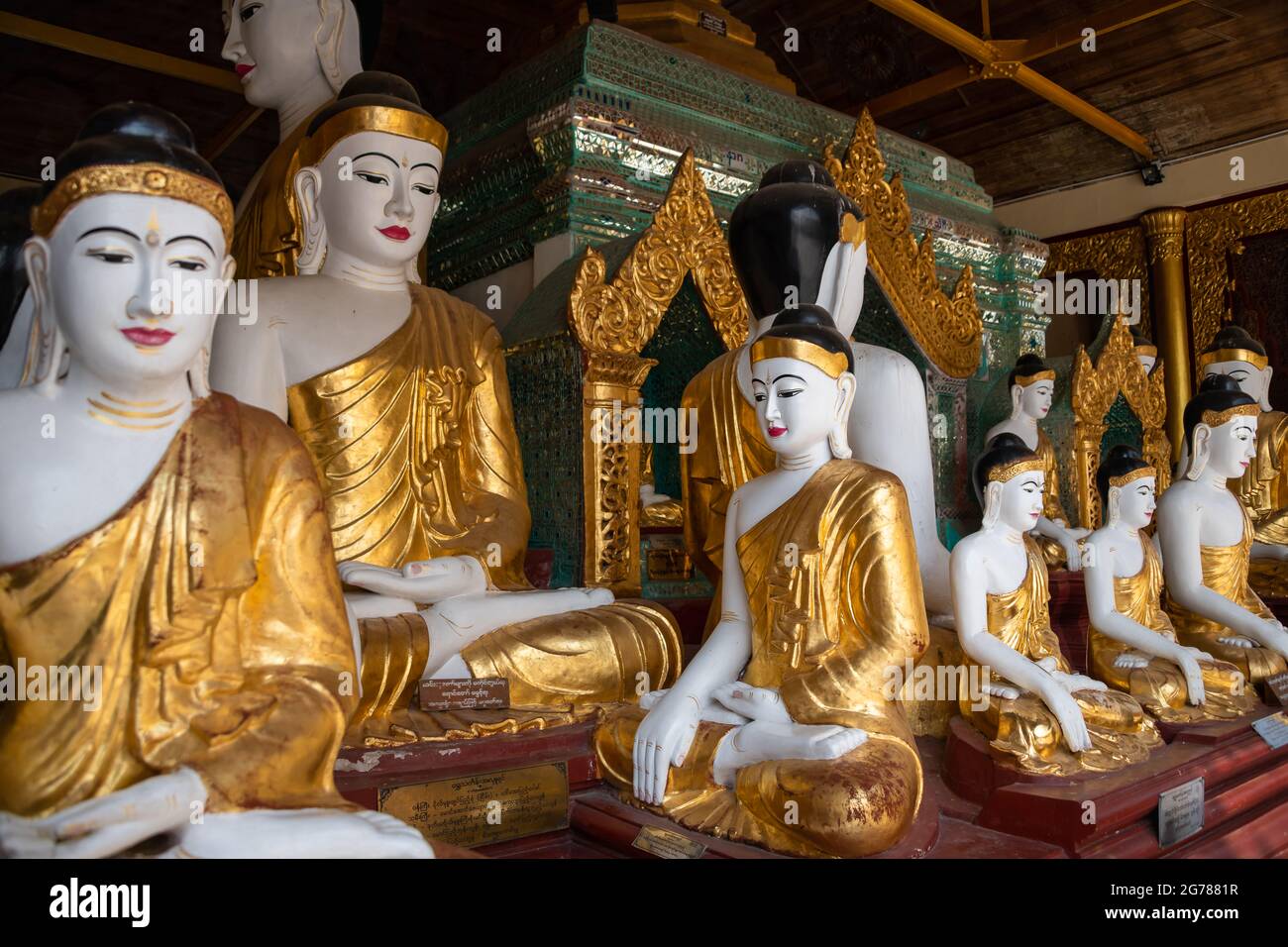 Yangon, Myanmar - January 2020: Golden Buddha statues, Shwedagon Pagoda Stock Photo