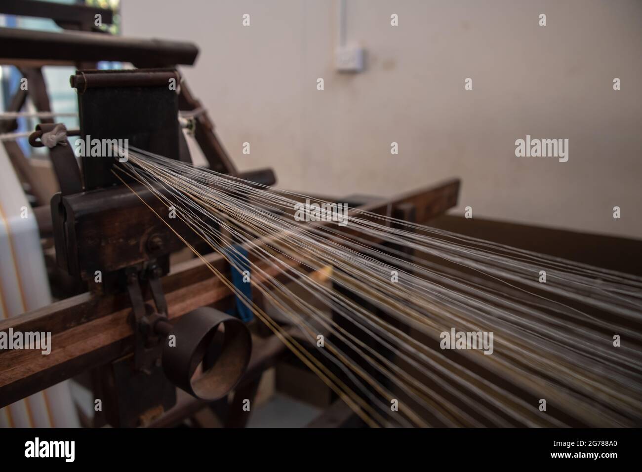 Close up of threads created in the process of spinning yarn for the textile industry. Weaving and warping abstract view. Stock Photo