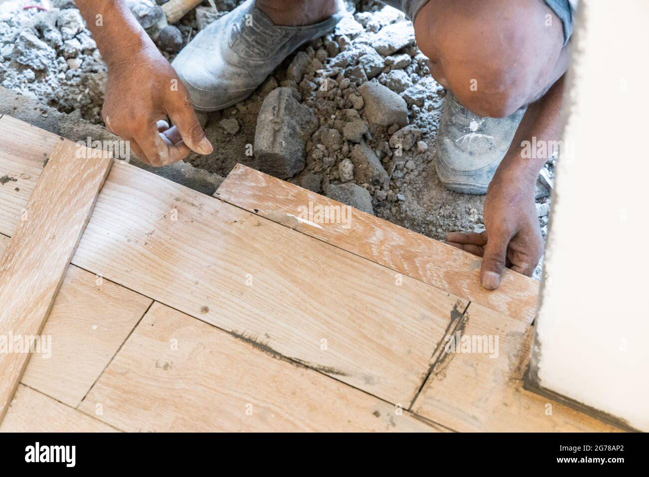 Worker installing ceramic floor tile at door edge Stock Photo