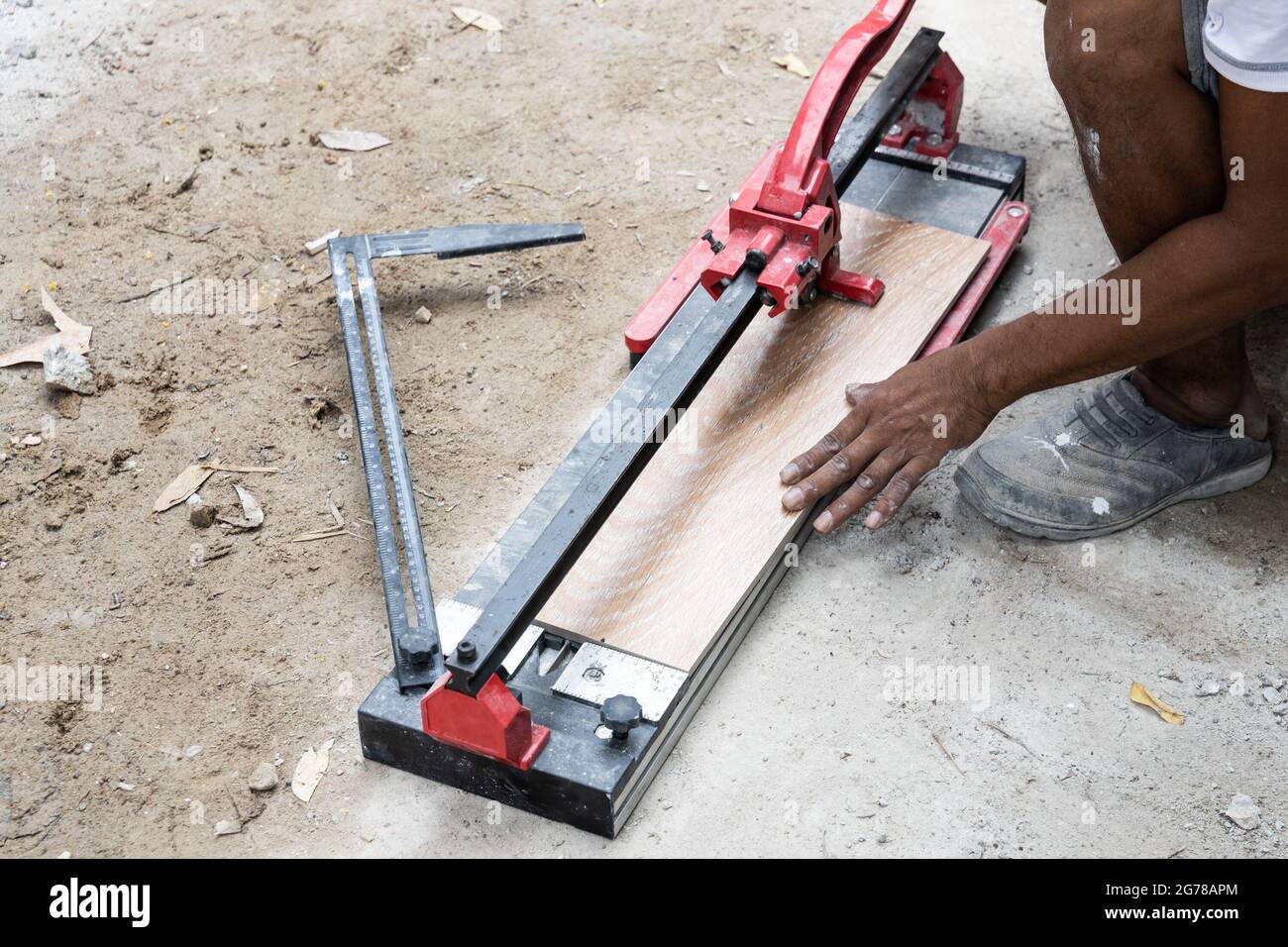 Worker cutting ceramic tile with tile cutter tool Stock Photo Alamy