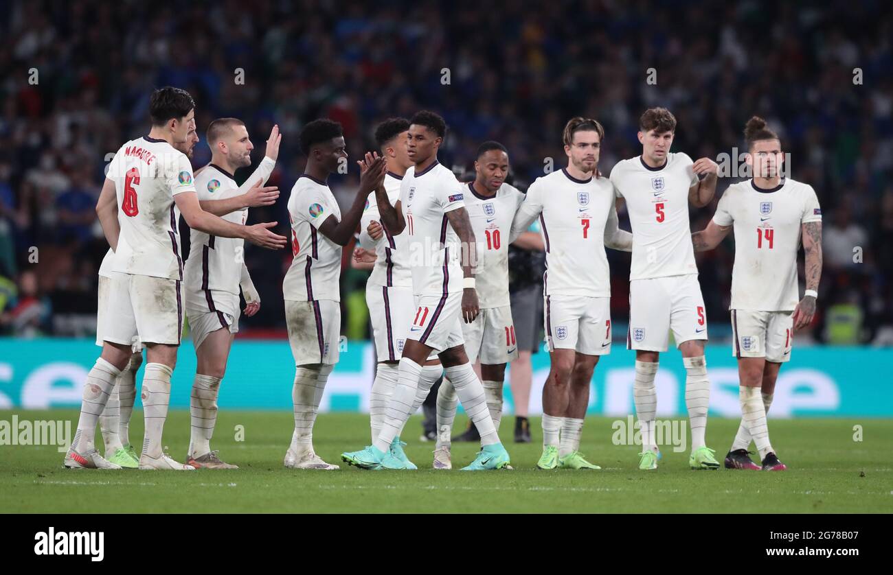 England's Marcus Rashford is consoled by team mates after missing from the penalty spot during the shoot out following the UEFA Euro 2020 Final at Wembley Stadium, London. Picture date: Sunday July 11, 2021. Stock Photo