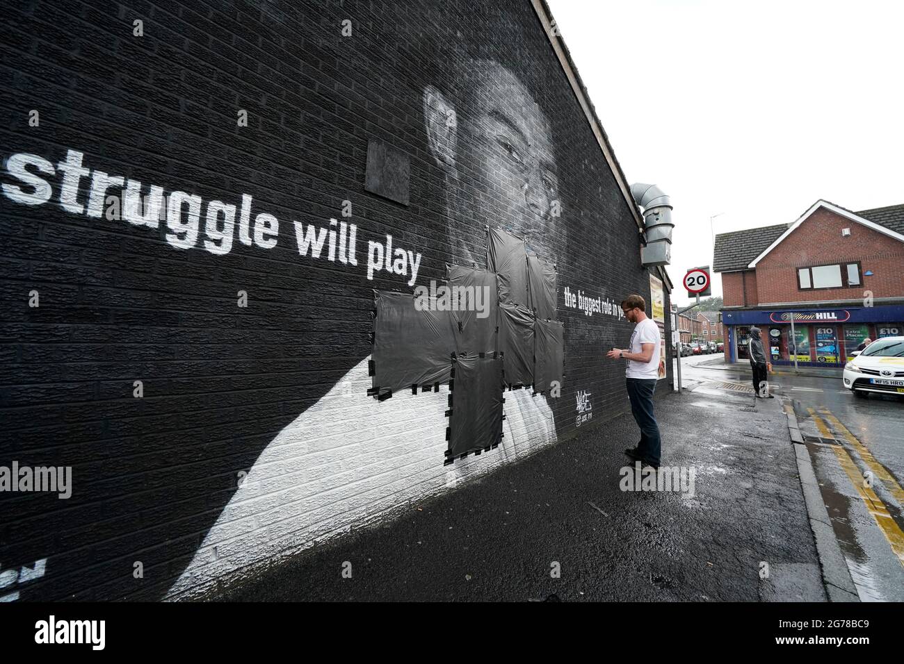 Ed Wellard, from Withington, tapes bin liners across offensive wording