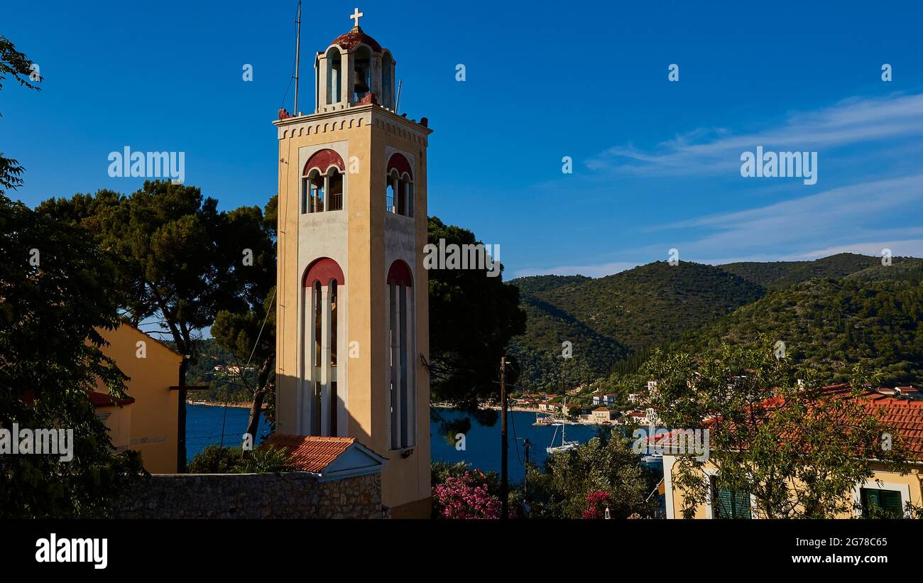 Ionian Islands, Ithaka, island of Ulysses, capital, Vathi, church tower of the Orthodox Church 'Holy Mother of God the Virgin Gardelaki', IN Koimiseos Theotokou, behind the church tower is the bay of Vathi, blue sky, individual clouds of clouds Stock Photo