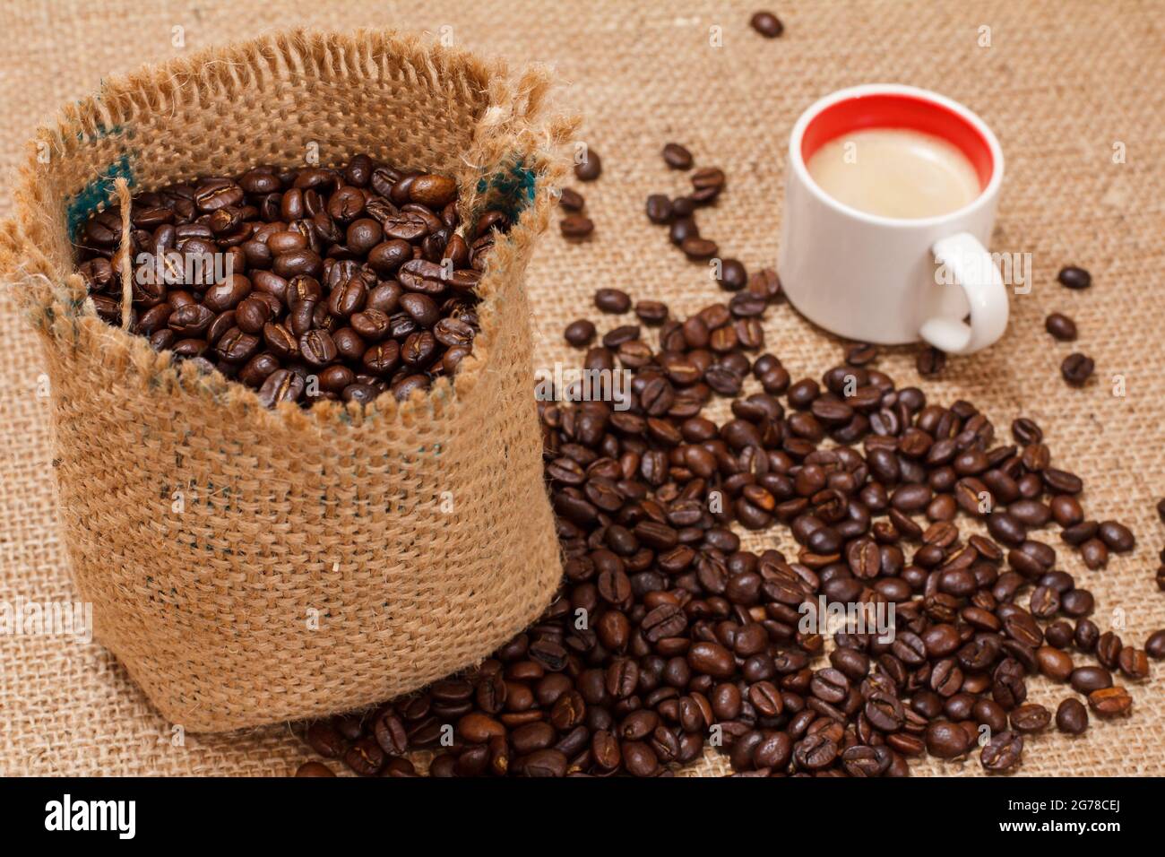 Cup of coffee and roasted coffee beans in a canvas sack. Stock Photo