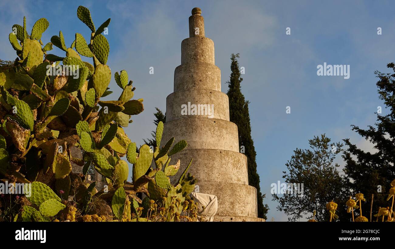 Ionian Islands, Ithaca, island of Odysseus, northwest, mountain village Exogi, pyramids of Exogi, work of the eccentric millionaire Ioannis Papadopulos. Parents grave. Masonic symbols, built in the 1930s, pyramid in center, cactus plant on the left, blue sky with clouds Stock Photo