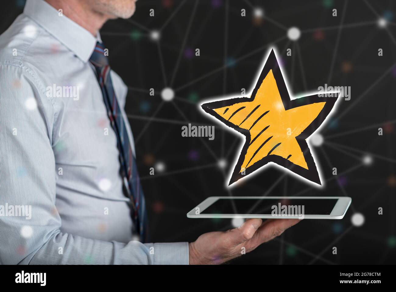 Favorite star concept above a tablet held by a man Stock Photo