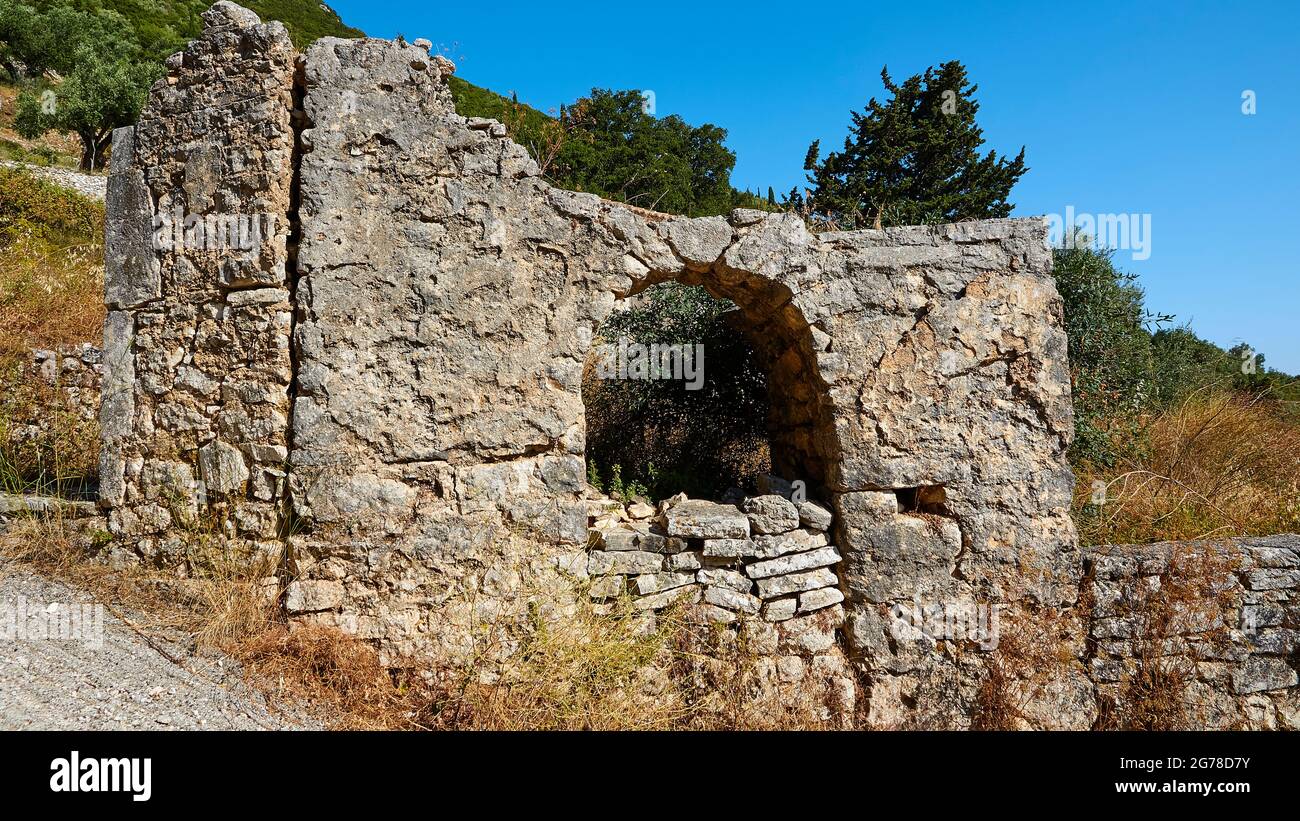 Ionian Islands, Ithaka, island of Odysseus, Vathi, district Perachori, lies on a wooded mountain slope, building ruin, brick arched window, blue sky Stock Photo
