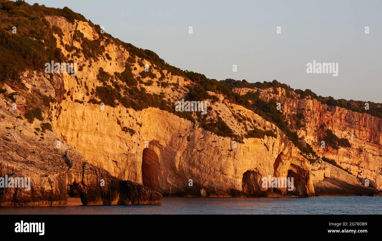 Ionian Islands, Zakynthos, northeast coast, Blue Caves, Blue Grottoes, morning light, grottos almost filling the screen, three rock arches, light blue sky Stock Photo