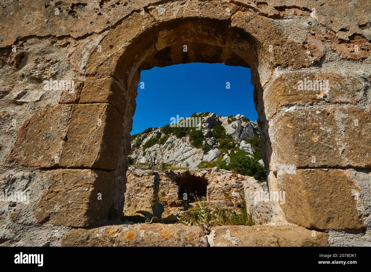 Ionian Islands, Zakynthos, mountain near Zakynthos town, Monte Yves, monastery on the summit, Panagia Skopiotissa, 15th century AD, stands on ruins of an ancient Artemis temple, dark blue sky, view through the arch of a wall to other buildings of the monastery Stock Photo