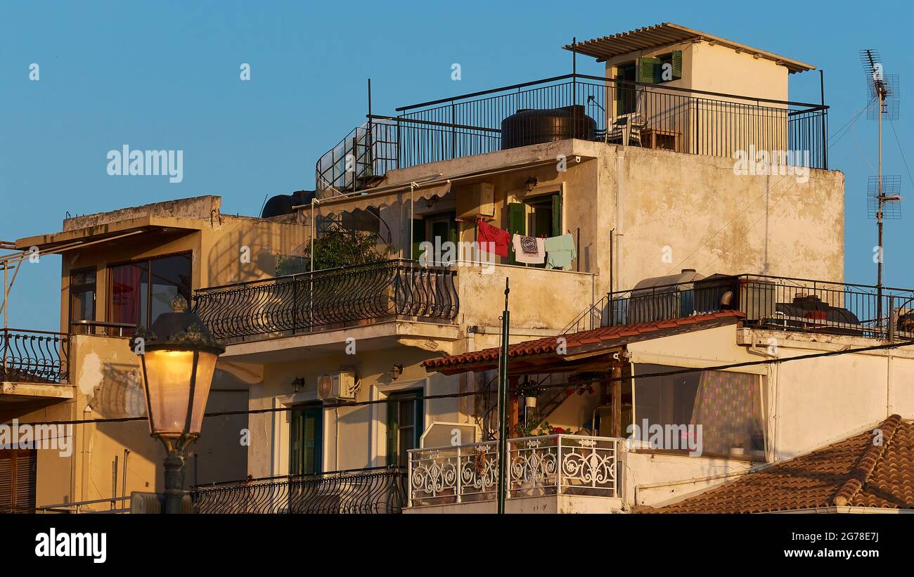 Zakynthos, Zakynthos Town, downtown, buildings, morning light, nested houses, roof terrace, lantern in foreground, laundry on the line, blue sky Stock Photo
