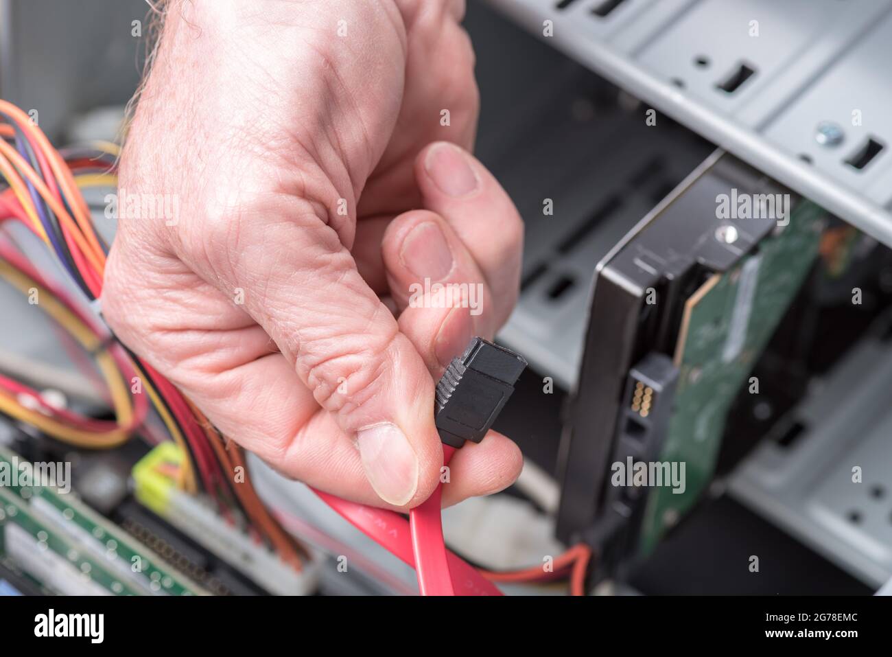 Computer technician holding a sata cable Stock Photo Alamy