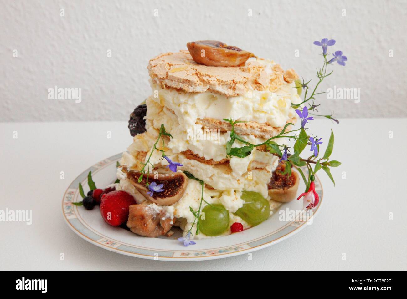 Dessert, meringue with figs, strawberries, grapes, mascarpone, Stock Photo