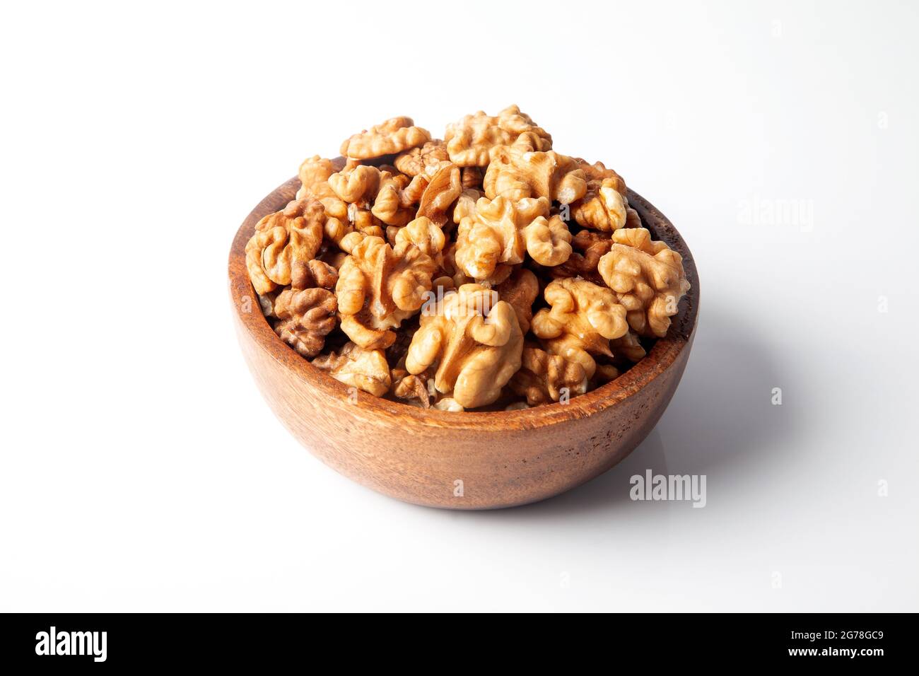 Walnuts in a bowl on a white background Stock Photo