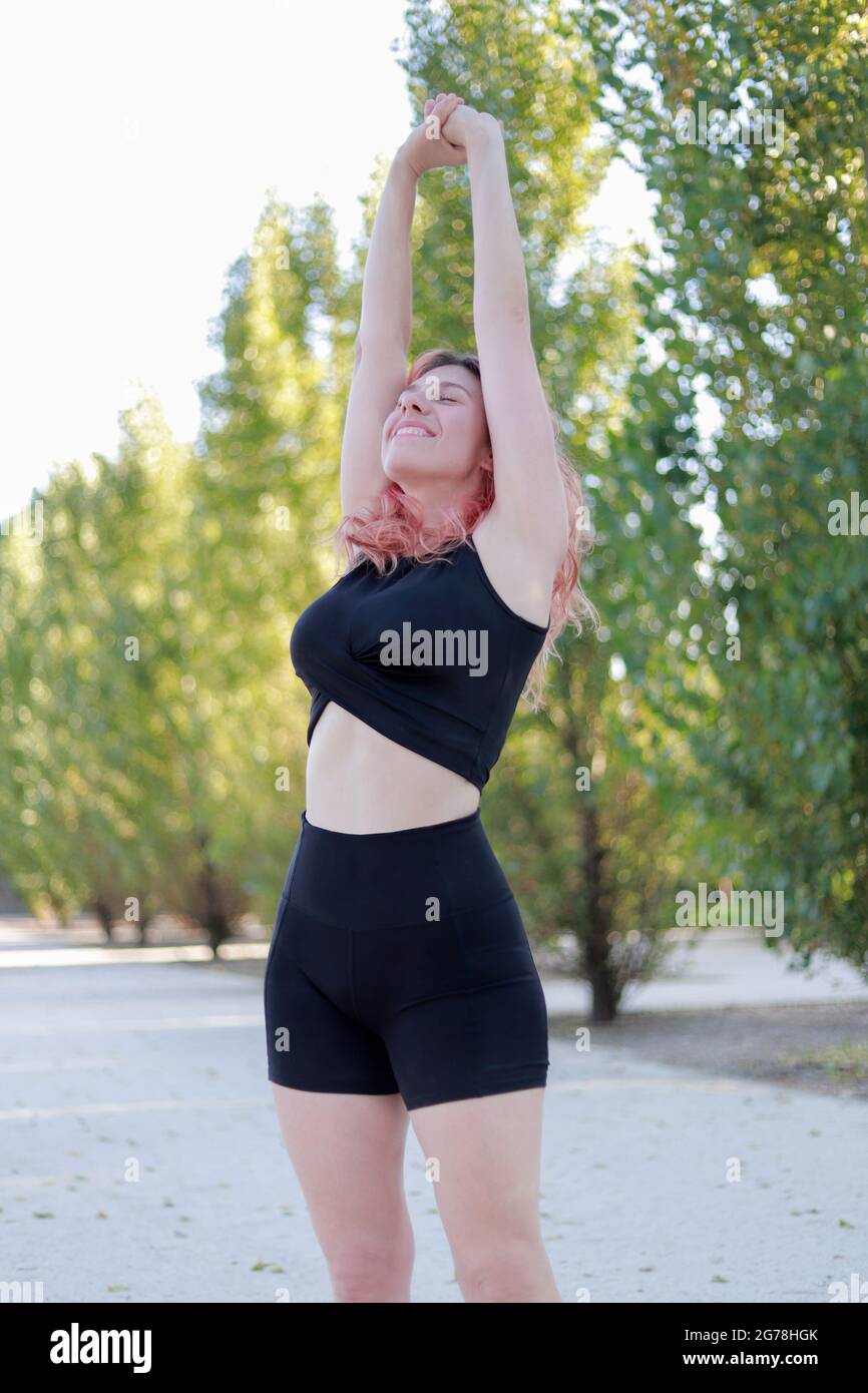 woman stretching in sportswear in the park Stock Photo