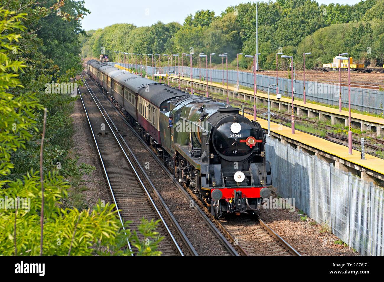 Preserved and restored steam locomotive, 34064 'Braunton' passes Tonbridge West railway yard with a special excursion train from London Stock Photo