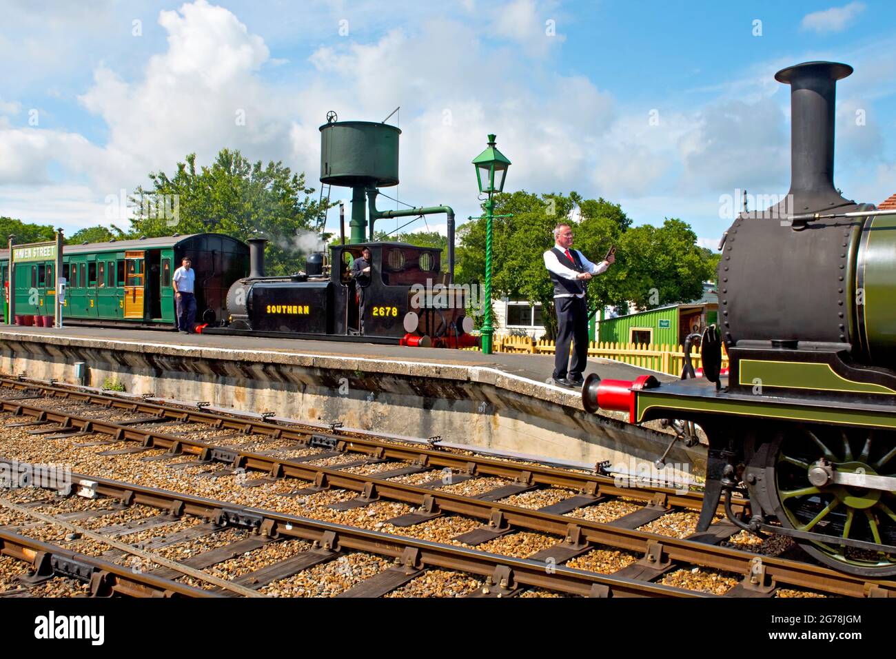 The signalman prepares to exchange single line tokens at Havenstreet station on the Isle of Wight Steam Railway Stock Photo
