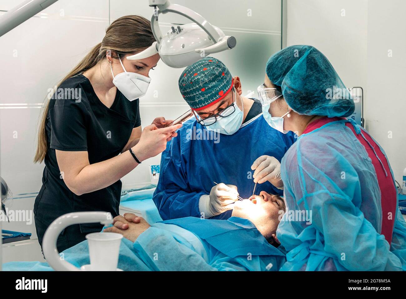 Young woman taking picture of a patient during dental revision in dental  clinic Stock Photo - Alamy