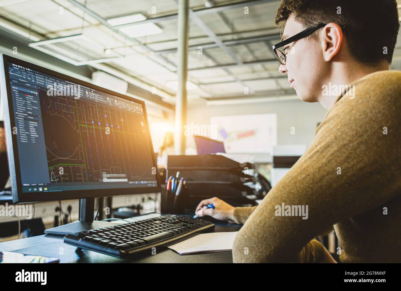 Engineer designer working on desktop computer in factory Stock Photo Alamy