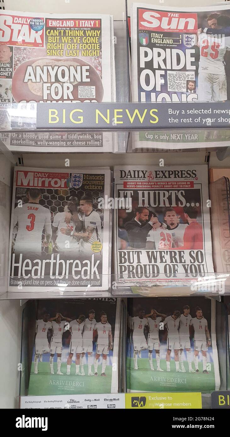 London, UK, 12 July 2021: Newspaper front pages cover England's defeat in the final of Euro 2020. The England men's football team lost on penalties to Italy at Wembley last night. The coverage emphases the disappointment but also the pride in the young at diverse team, who have sadly been subject to racial abuse online since the game. Many of the papers used photos of England manager Gareth Southgate consoling Bukayo Saka after his penalty attempt was saved by the Italian goalkeeper. Anna Watson/Alamy Live News Stock Photo