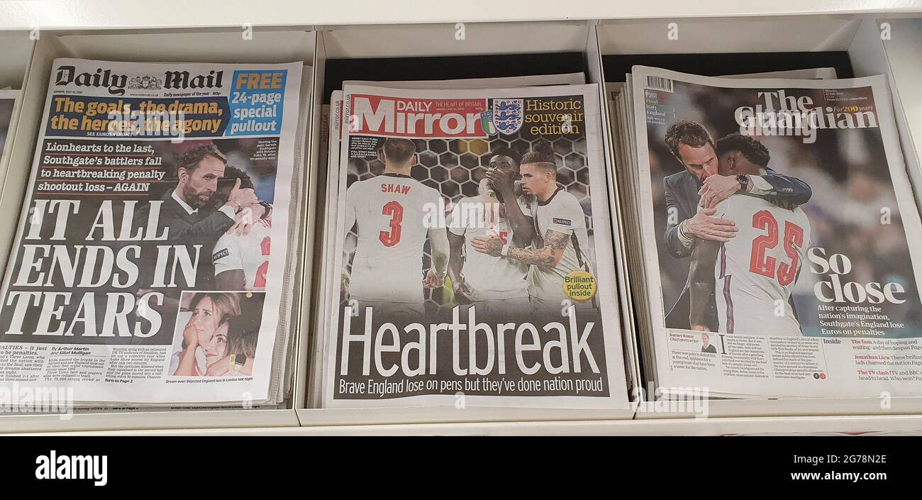 London, UK, 12 July 2021: Newspaper front pages cover England's defeat in the final of Euro 2020. The England men's football team lost on penalties to Italy at Wembley last night. The coverage emphases the disappointment but also the pride in the young at diverse team, who have sadly been subject to racial abuse online since the game. Many of the papers used photos of England manager Gareth Southgate consoling Bukayo Saka after his penalty attempt was saved by the Italian goalkeeper. Anna Watson/Alamy Live News Stock Photo