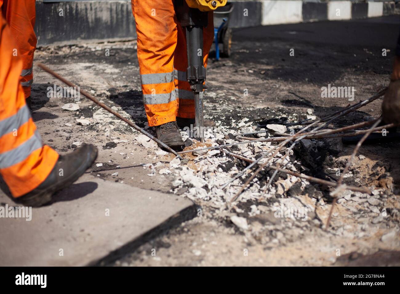 Reblocking Work with a jackhammer. Asphalt repair. Road surface restoration. The ...